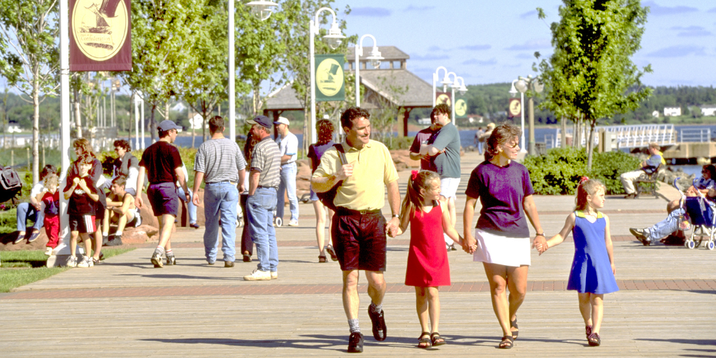 Family walking along the waterfront promenade at Confederation Landing Park