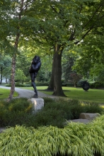 The curving lines of the sculpture, “Night”, are echoed in the trunks of the trees and the sweep of the entrance drive.