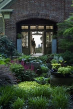 A dramatic glassed hall allows views from the entrance, through the house, linking front garden to back, then back garden to wooded hillsides and Cleveland beyond.