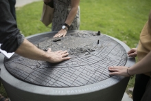 Detail of map with people encouraged to feel the bronze details