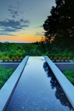 Careful attention to context and geometry created a vista where the walls of the reflecting pool align with buildings in the skyline and the sculpture of “Day” appears to float on a thin skim of water reflecting the sky.