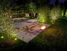 The pool terrace and fireplace create an invitation to be outside in the evening hours, demonstrating contemporary expectations on indoor-outdoor living.