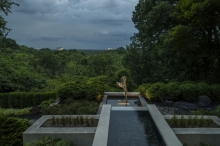 The drama of the landscape culminates in the figure of “Day”, appearing to float over the infinity edge of the pool, as a storm rolls over downtown and Lake Erie.