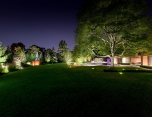 This singular title image reveals how accent lighting expands the precinct of the house into the generous lawn defined by an urban garden.