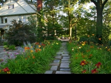 Named for their granddaughter, colorful "Lily's Lane" is punctuated by reclaimed sandstone stepping stones. This house elevation was revealed after 100 years, transforming both access to light and stature.