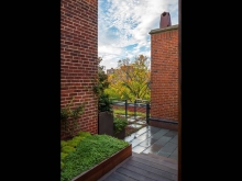 Transition to rooftop areas beyond is defined by a contemporary gate, multi levels of planting and existing architectural elements – framing views from the dining terrace.