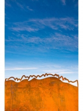 Light passes through perforations in the steel wall, symbolic of the northern lights