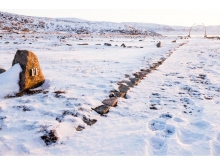 The central axial pathway terminates at an archway of standing bowhead whale jaw bones