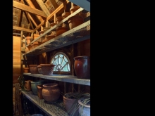 The interiors of the new summer houses, framed with reclaimed lumber and punctuated with salvaged spiderweb windows, are designed to hold the owner's collection of more than 300 containers.